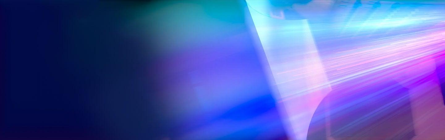 rays of purple and pink light illuminating a screen in an IMAX movie theatre