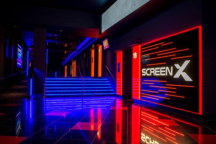 ScreenX logo in lights in the lobby of a theatre