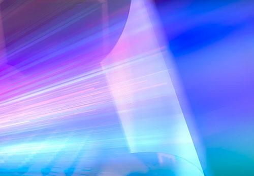 rays of purple and pink light illuminating a screen in an IMAX movie theatre