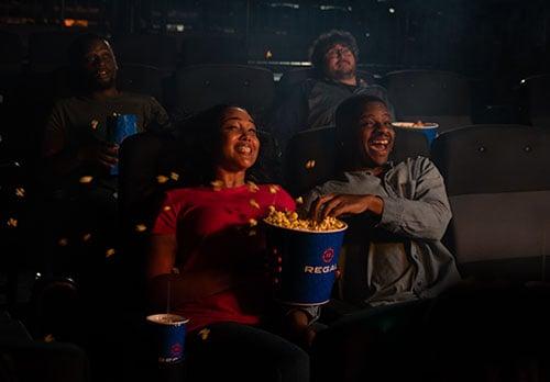 friends experiencing the movement of 4dx, popcorn is spilling everywhere