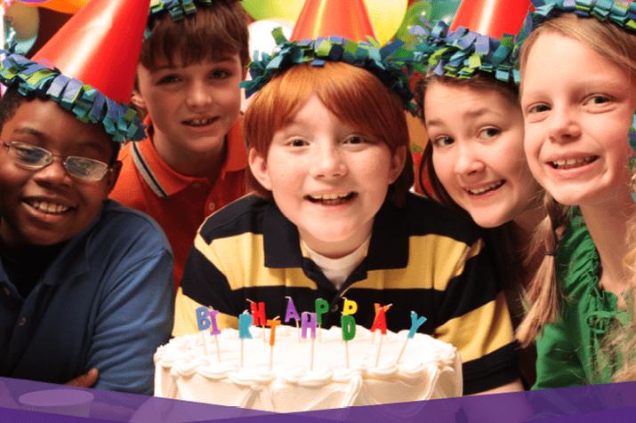 Kids celebrating a friend's birthday party at the movies.