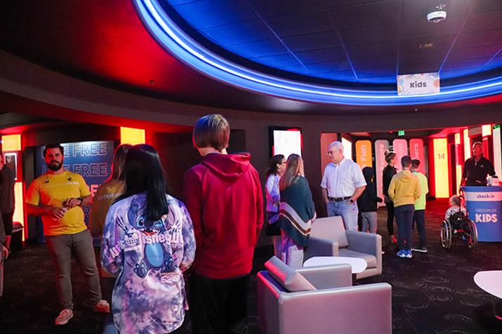 Church group meeting in a theatre lobby before worship.